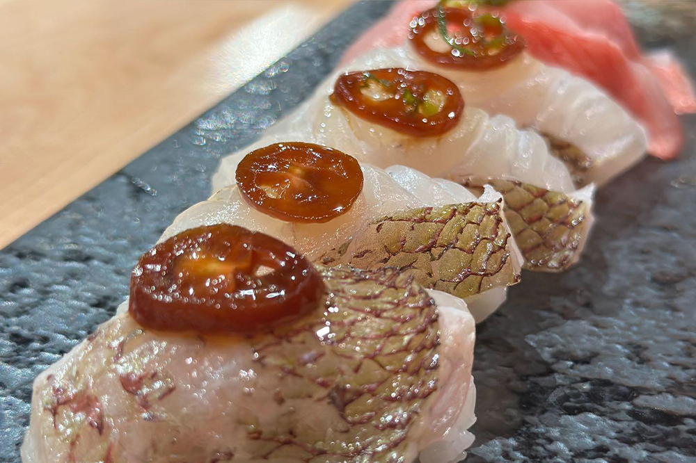 White fish nigiri topped with marinated tomato